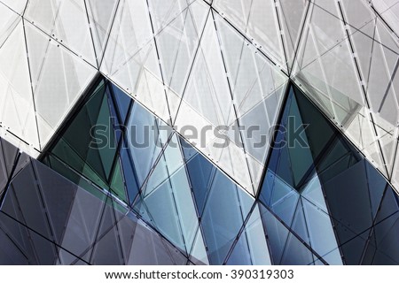 Double exposure photo of contemporary wall / facade fragment gave this realistic but unreal architectural composition. Polygonal geometric pattern in blue and light gray colors.