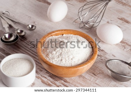 ingredients and tools to make a cake, flour, sugar,eggs, horizontal, close up