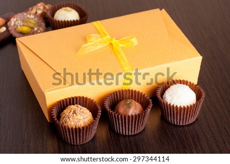 Chocolate handmade candies on a black table. Chocolate box, close up
