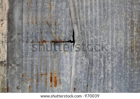 corrugated metal wall with a rip