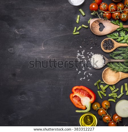 Healthy foods, cooking and vegetarian concept  cherry tomatoes, wild rice, spices, salt border ,place for text  on wooden rustic background top view close up