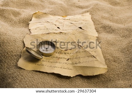 Old letter and golden compass
