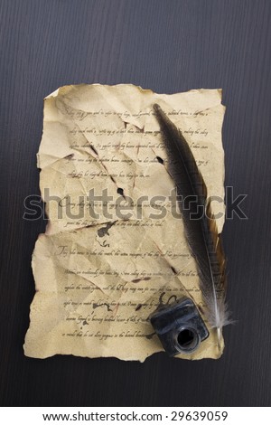 A beautiful old feather on an old letter