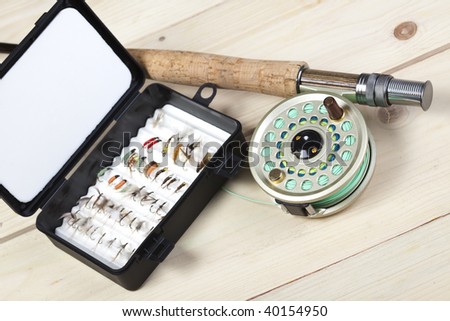 Fly fishing rod and reel with a yellow popping bug