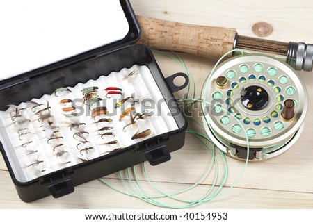 Fly fishing rod and reel with a yellow popping bug