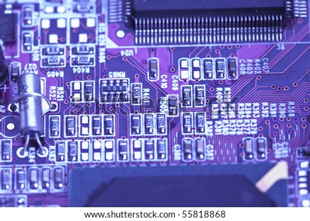 A close up shot of the backside of a computer circuit board, also known as a motherboard.