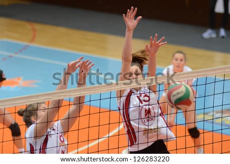KAPOSVAR, HUNGARY - JANUARY 27: Agnes Recsei (in white 13) in action at the Hungarian I. League volleyball game Kaposvar (white) vs Ujpest (purple), January 27, 2013 in Kaposvar, Hungary.