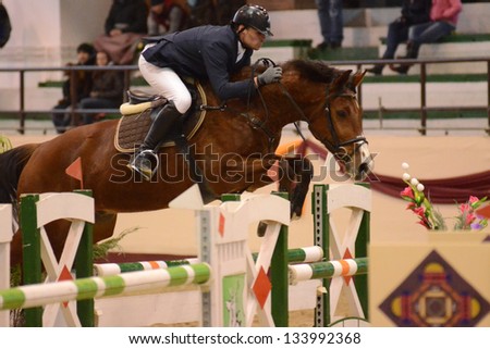 KAPOSVAR, HUNGARY - MARCH 24: Andras Marton jumps with his horse (Dollar) on the Masters Tournament International Jumping Competition, March 24, 2013 in Kaposvar, Hungary
