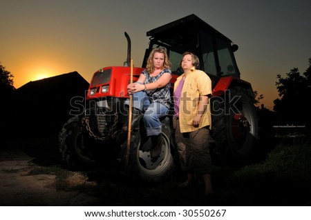 Two young women with red tractor