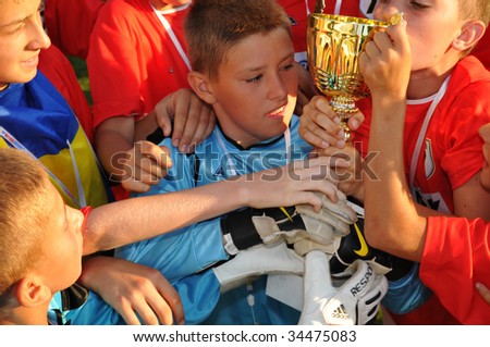 KAPOSVAR, HUNGARY - JULY 24: Ukrainian winner soccer players are glad at the V. Youth Football Festival Under 12 Final -  FK Tuzla (BIH) vs FC Munkachevo (UKR) - July 24, 2009 in Kaposvar, Hungary.