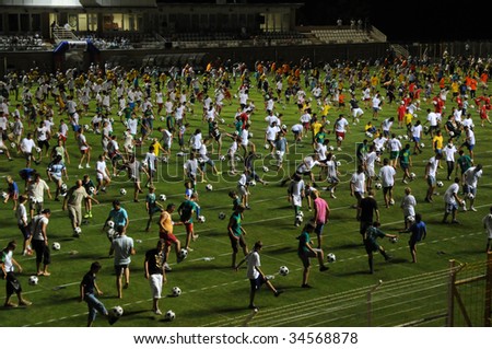 KAPOSVAR, HUNGARY - JULY 23: Many competitors at the Guinness world record breaking attempt (Most people keep the football in the air Juggling together) - July 23, 2009 in Kaposvar, Hungary