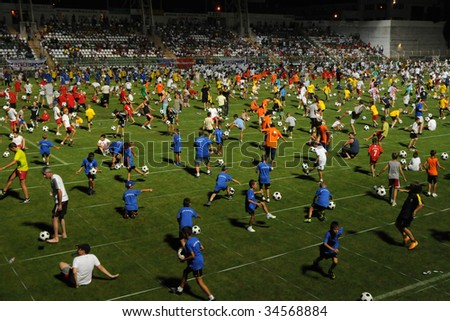 KAPOSVAR, HUNGARY - JULY 23: Many competitors at the Guinness world record breaking attempt (Most people keep the football in the air Juggling together) - July 23, 2009 in Kaposvar, Hungary