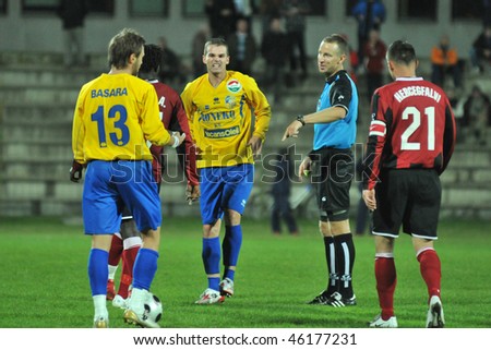SIOFOK, HUNGARY - OCTOBER 3: The referee explains to the players at a Hungarian National Championship soccer game Siofok vs. Budapest Honved October 3, 2008 in Siofok, Hungary.