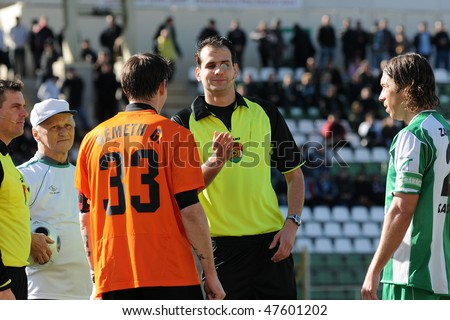 KAPOSVAR, HUNGARY - FEBRUARY 27: The referee adds lustre to the money before a Hungarian National Championship soccer game Kaposvar vs Budapest Honved February 27, 2010 in Kaposvar, Hungary.