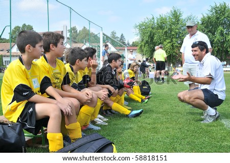 KAPOSVAR, HUNGARY - JULY 19: The Cyprian players listen to their trainer at a VI. Youth Football Festival match Efthymiades FA (CYP) vs. Academia Venezolana (VEN)- July 19, 2010 in Kaposvar, Hungary