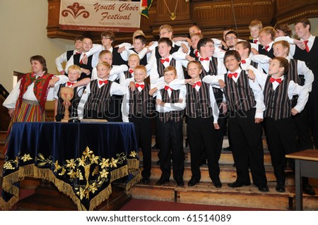 KAPOSVAR, HUNGARY - AUGUST 26: Members of the Suae Music School Choir (EST) sing at the IV. Pannonia Cantat Youth Choir Festival August 26, 2010 in Kaposvar, Hungary