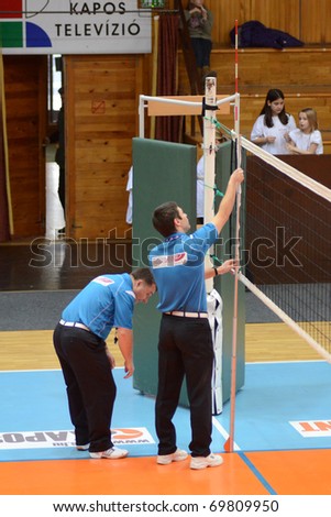 KAPOSVAR, HUNGARY - JANUARY 23: The referees measure it the altitude of the volleyball net at the Hungarian NB I. woman volleyball game Kaposvar vs Miskolc, January 23, 2011 in Kaposvar, Hungary.
