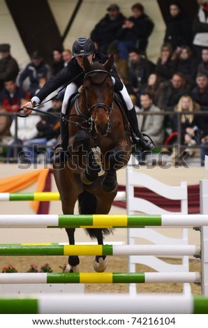 KAPOSVAR, HUNGARY - MARCH 27: Lukas Koza jumps with his horse (El Camp) on the Masters Tournament International Jumping Competition, March 27, 2011 in Kaposvar, Hungary.
