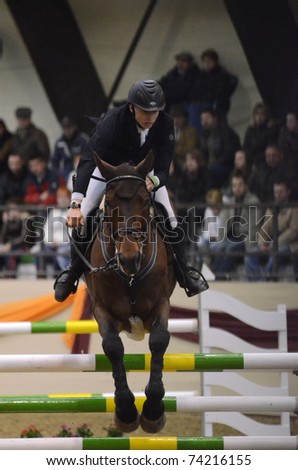 KAPOSVAR, HUNGARY - MARCH 27: Lukas Koza jumps with his horse (El Camp) on the Masters Tournament International Jumping Competition, March 27, 2011 in Kaposvar, Hungary