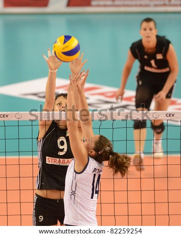 DEBRECEN, HUNGARY - JULY 9: Zsanett Miklai (in black 9) in action a CEV European League woman's volleyball game Hungary (black) vs Israel (white) on July 9, 2011 in Debrecen, Hungary.