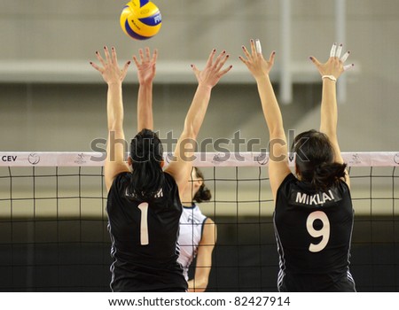 DEBRECEN, HUNGARY - JULY 9: Zsanett Miklai (in black 9) in action a CEV European League woman\'s volleyball game Hungary (black) vs Israel (white) on July 9, 2011 in Debrecen, Hungary.