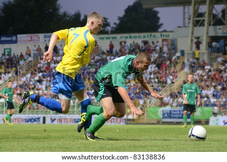 KAPOSVAR, HUNGARY - JULY 18: Unidentified players in action at the VII. Youth Football Festival under 16 match SYFA West R (yellow)(SCO) vs. Rakoczi FC (green) (HUN) on July 18, 2011 in Nagyberki, Hungary