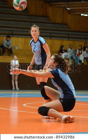 KAPOSVAR, HUNGARY - OCTOBER 16: Petra Kulcsar (R) in action at the Hungarian NB I. League woman volleyball game Kaposvar (blue) vs Ujpest (white), October 16, 2011 in Kaposvar, Hungary.