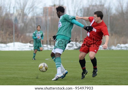 KAPOSVAR, HUNGARY - FEBRUARY 18: Haruna Jammeh (in green) in action at a friendly soccer game Kaposvar (green) vs. Dombovar (red) - February 18, 2012 in Kaposvar, Hungary.