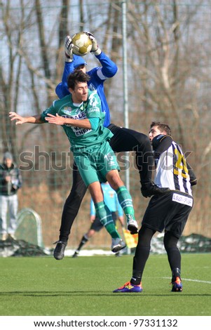 KAPOSVAR, HUNGARY - FEBRUARY 22: Unidentified players in action at a Hungarian National Cup soccer game Kaposvar (green) vs Papa (white) February 22, 2012 in Kaposvar, Hungary.