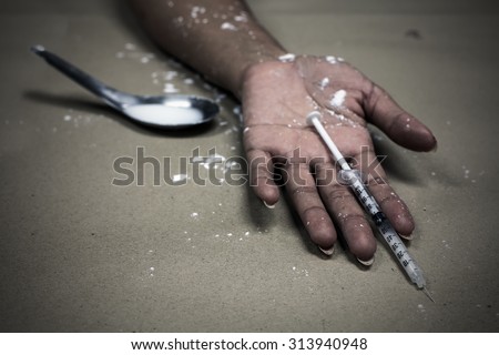 overdose asian female drug addict hand, drugs narcotic syringe in hand on the floor
