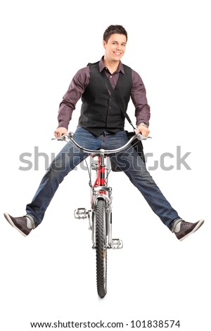 A studio shot of a young happy man riding a bike isolated on white background