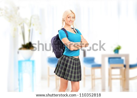 A female student standing in a school hall