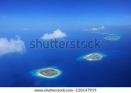Sun and clouds over islands in Laccadives sea, Maldives, shot with a tilt and shift lens