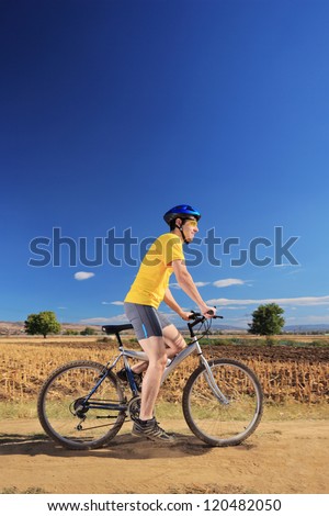 Biker in yellow shirt riding a bike on a sunny day, Macedonia
