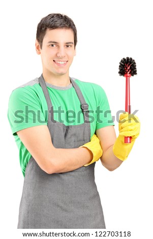 A smiling male cleaner holding a toilet broom isolated on white background