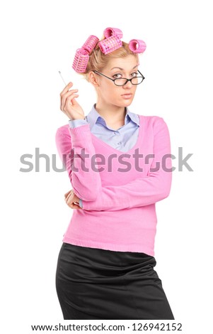A blond woman with hair rollers smoking a cigarette isolated on white background