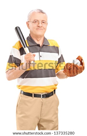 Smiling middle aged man holding a wooden baseball bat and glove with ball in it, isolated on white background