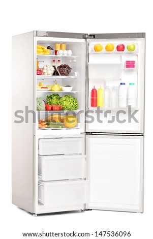 Open fridge full of healthy food products isolated on white background