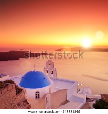 View of a blue dome of the church St. Spirou in Firostefani on the island of Santorini Greece, at sunset