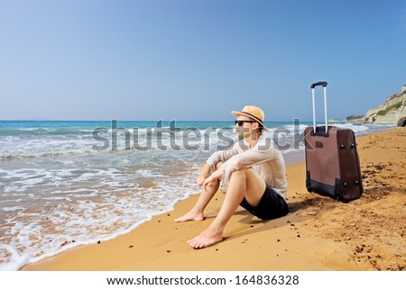Lost Tourist On A Beach Peroulades At Corfu Island, Greece With His Luggage