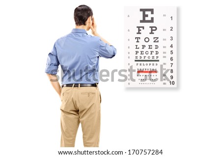 Portrait of a man taking eyesight test, isolated on white background