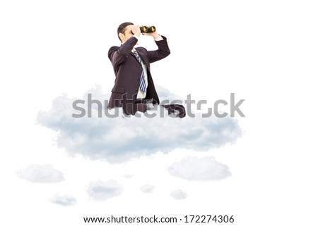 Young businessman looking through binoculars seated on cloud isolated on white background
