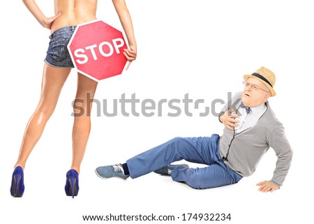 Senior gentleman looking at sexy woman with stop sign, and experiencing heart attack isolated on white background