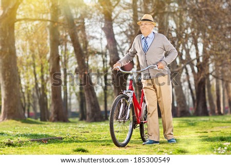 An elderly pushing his bike in outdoors