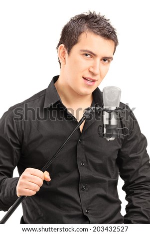 Elegant male singer holding a microphone isolated on white background