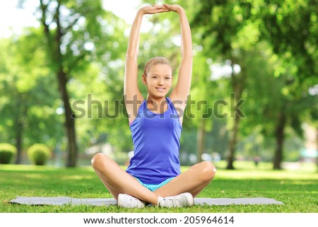 Young woman exercising in park on a sunny day