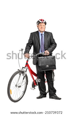 Full length portrait of a mature businessman posing in front of a bike isolated on white background
