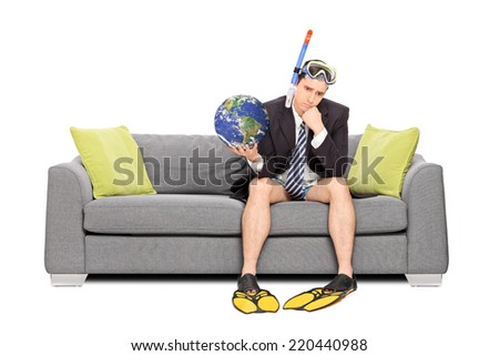 Sad businessman holding the earth and sitting on sofa isolated on white background. Earth image in public Domain and furnished by NASA
