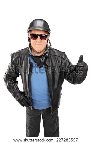 Vertical shot of a mature biker giving a thumb up isolated on white background