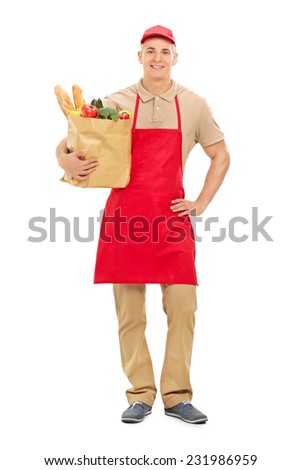 Full length portrait of a young market vendor holding a bag full of groceries isolated on white background